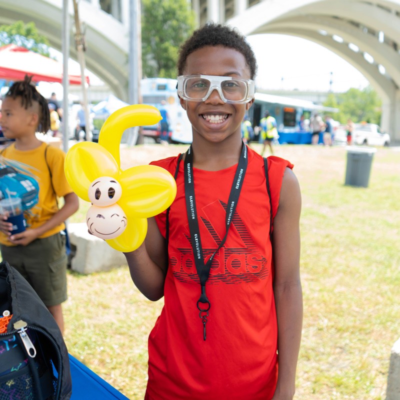Young boy holding a balloon animal
